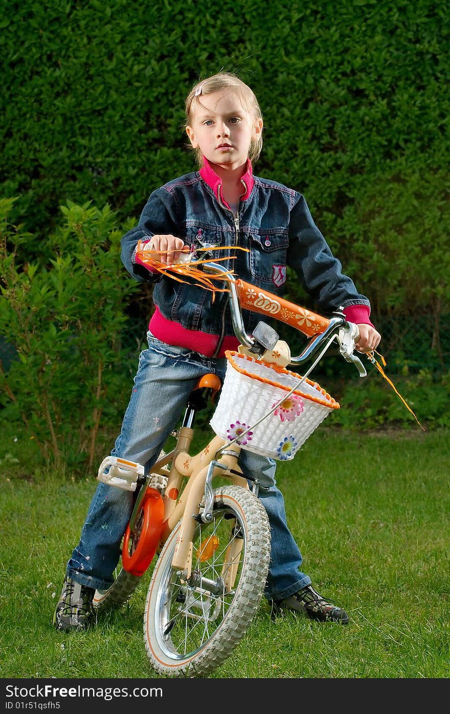 A young girl on a bicycle. A young girl on a bicycle.