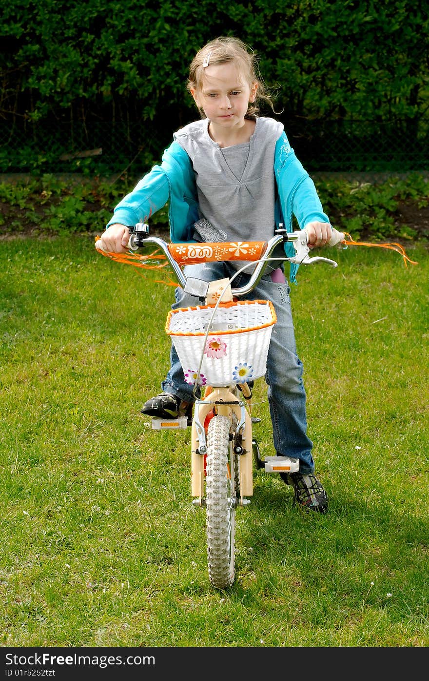 A young girl on a bicycle. A young girl on a bicycle.