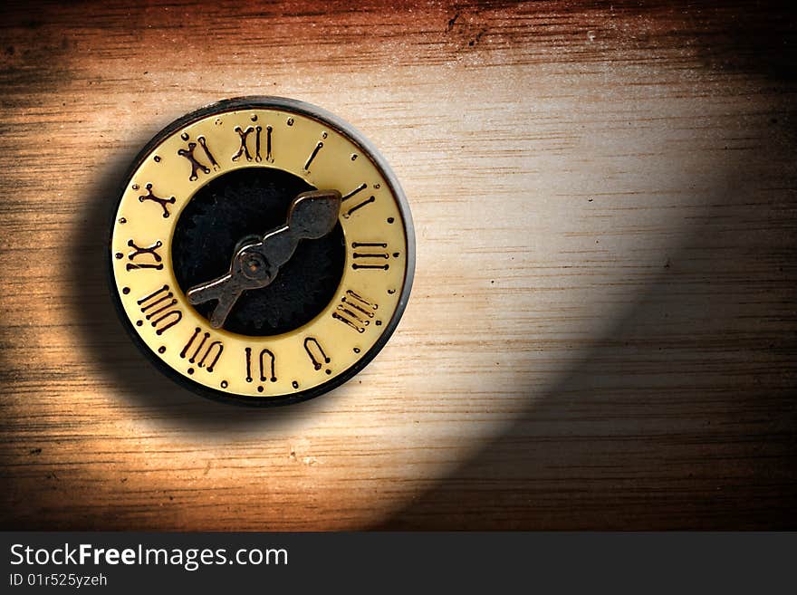 Old clock with roman numbers over wooden texture. Old clock with roman numbers over wooden texture