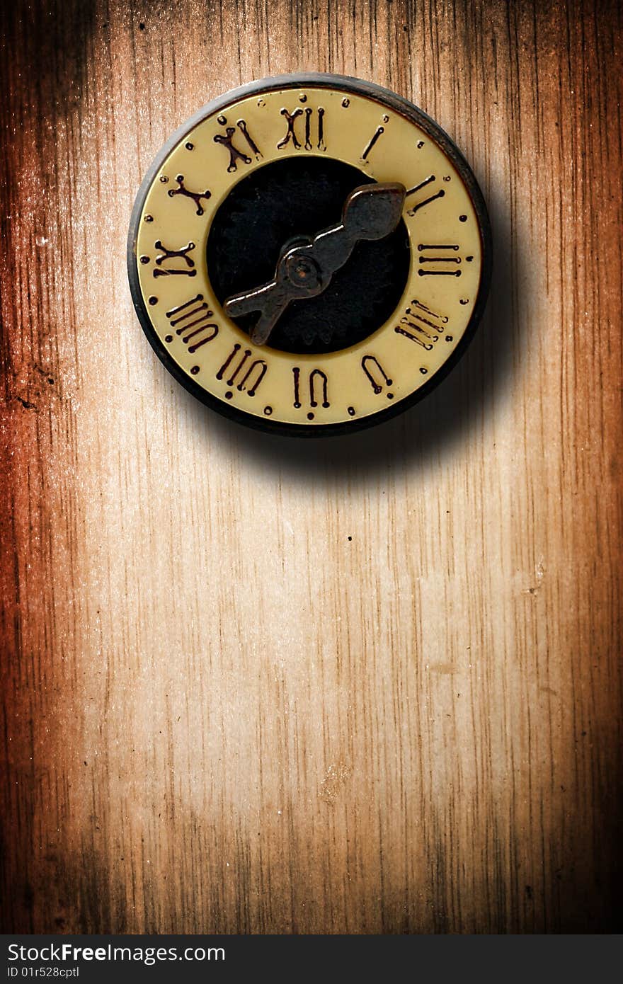 Old clock with roman numbers over wooden texture