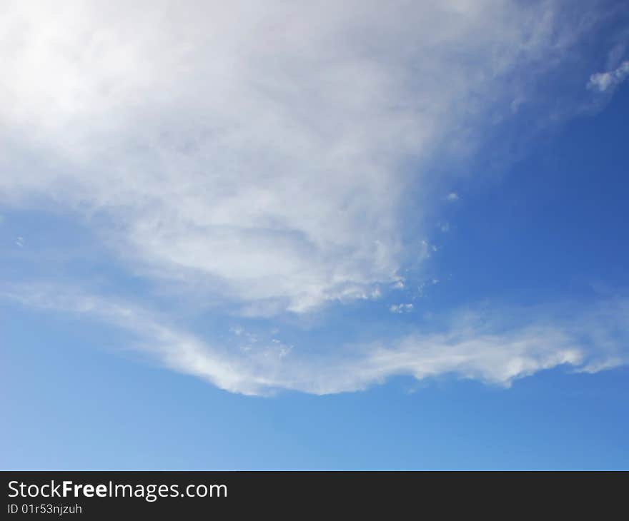 White Cumulus Humilis clouds forming against a blue sky as a young storm develops