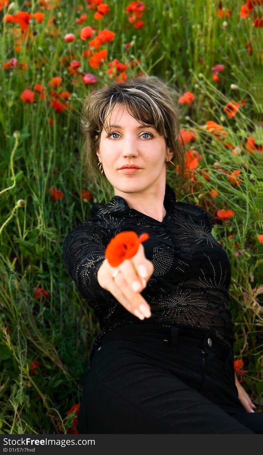 Portrait woman with poppy on nature