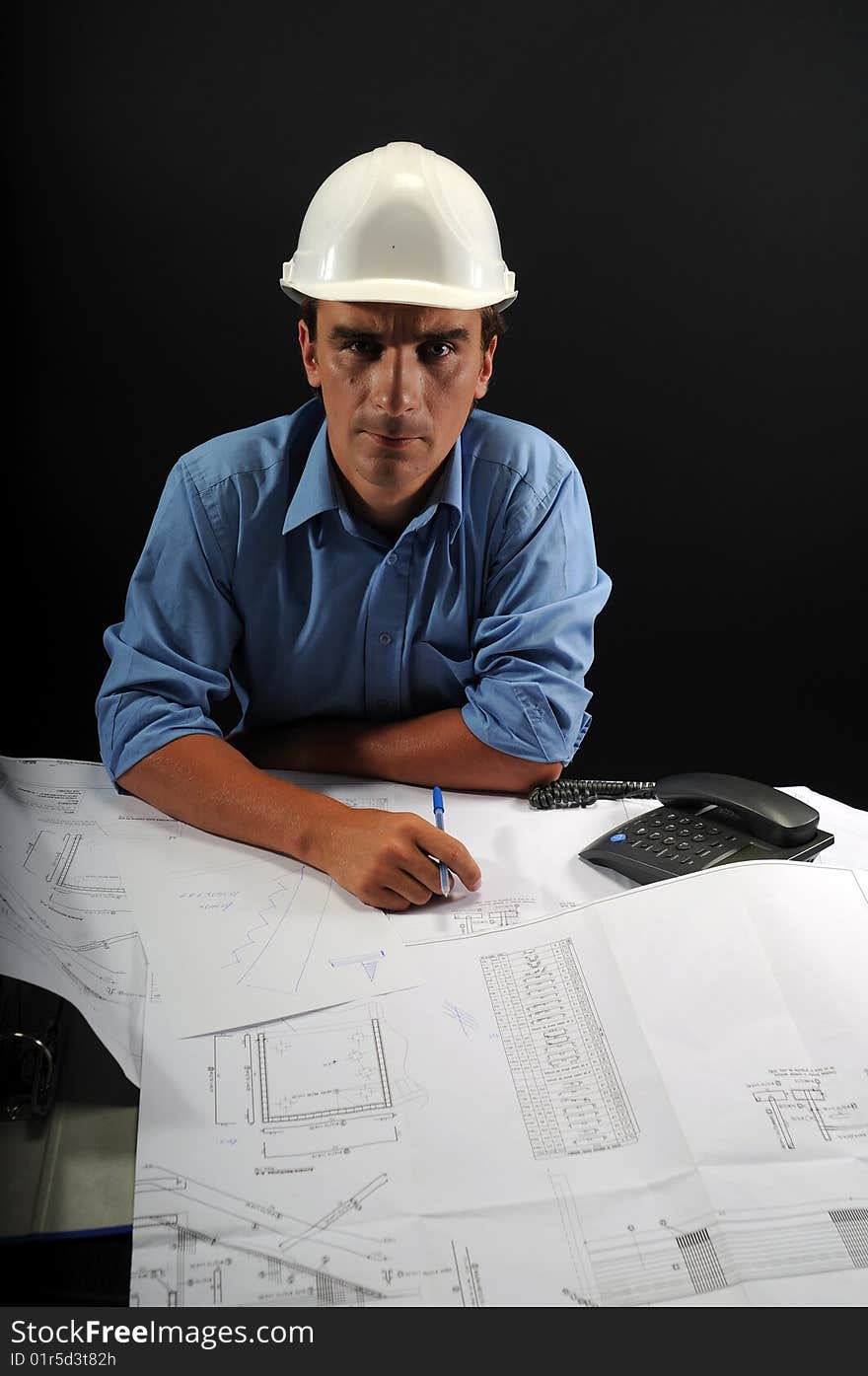 Engineer in low key over a black background