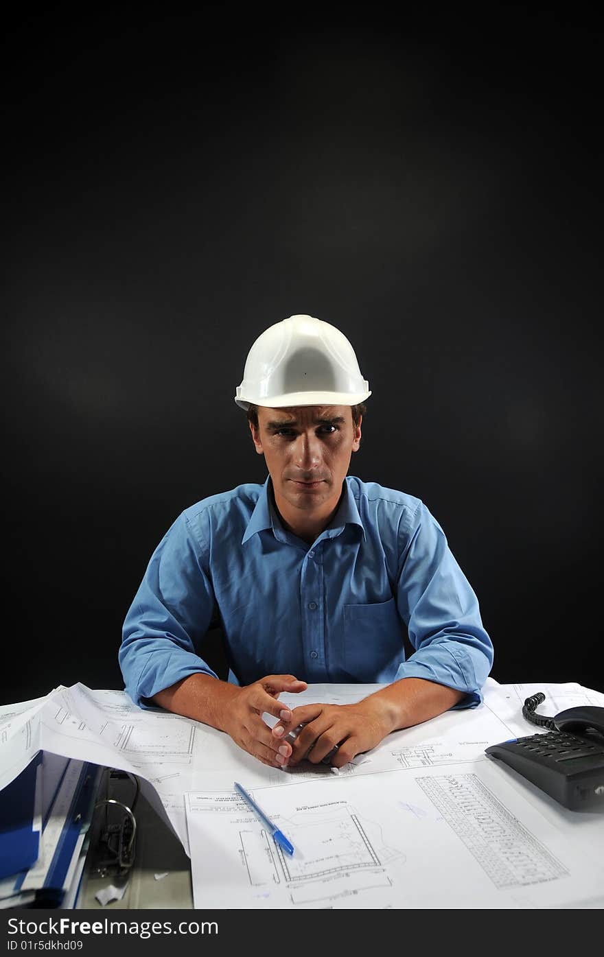 Engineer in low key over a black background