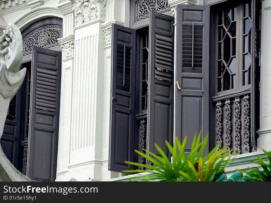 Elegant windows with fine tracery and gray wooden louvered shutters grace a Peranakan home on historic Emerald Hill - Xu Lei Photo / Lee Snider Photo Images. Elegant windows with fine tracery and gray wooden louvered shutters grace a Peranakan home on historic Emerald Hill - Xu Lei Photo / Lee Snider Photo Images.