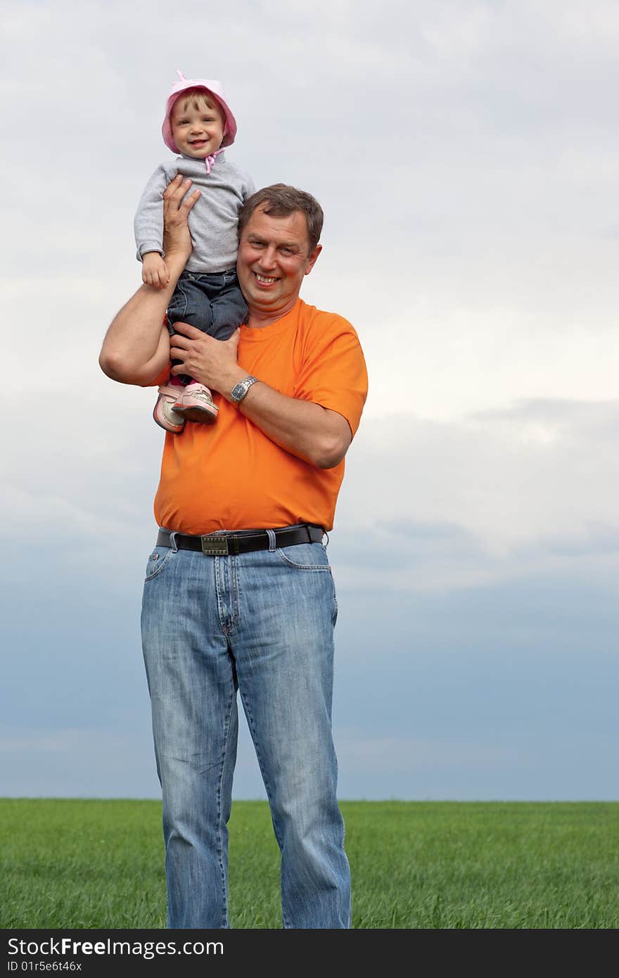 Outdoor portrait of a little girl with her grandfather. Outdoor portrait of a little girl with her grandfather