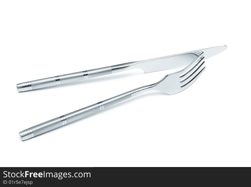 Steel knife and fork on a white background