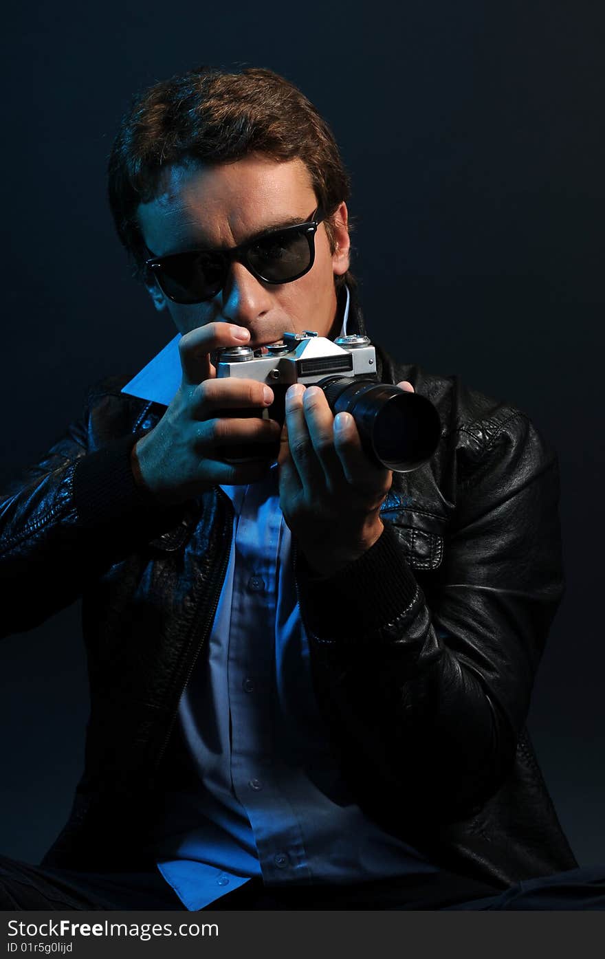 Photographer in low key over a black background