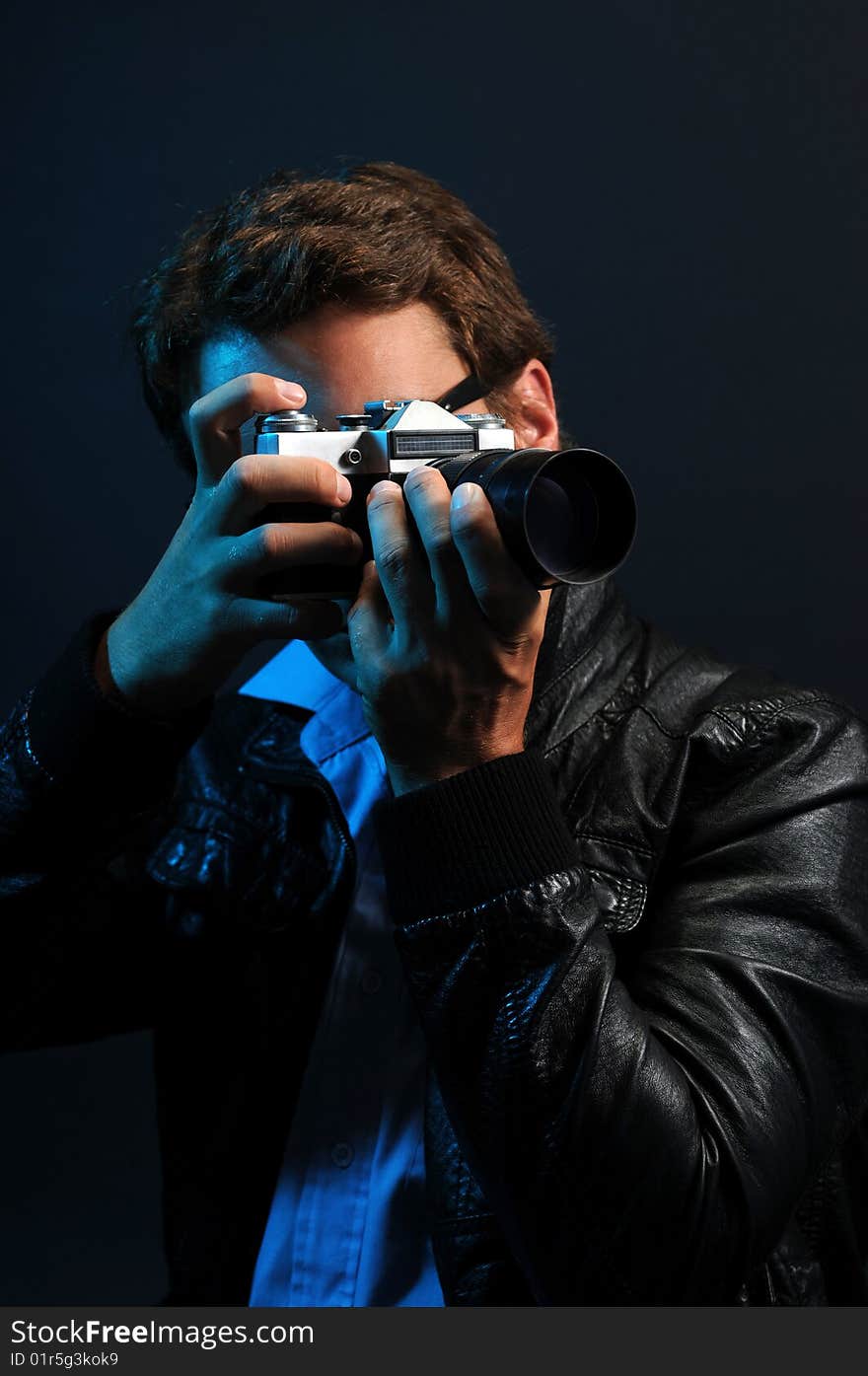 Photographer in low key over a black background