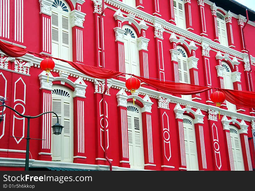 Beautifully restored early 20th century building painted bright red with cream louvered shutters, windows and pilasters in Chinatown - Xu Lei Photo / Lee Snider Photo Images. Beautifully restored early 20th century building painted bright red with cream louvered shutters, windows and pilasters in Chinatown - Xu Lei Photo / Lee Snider Photo Images