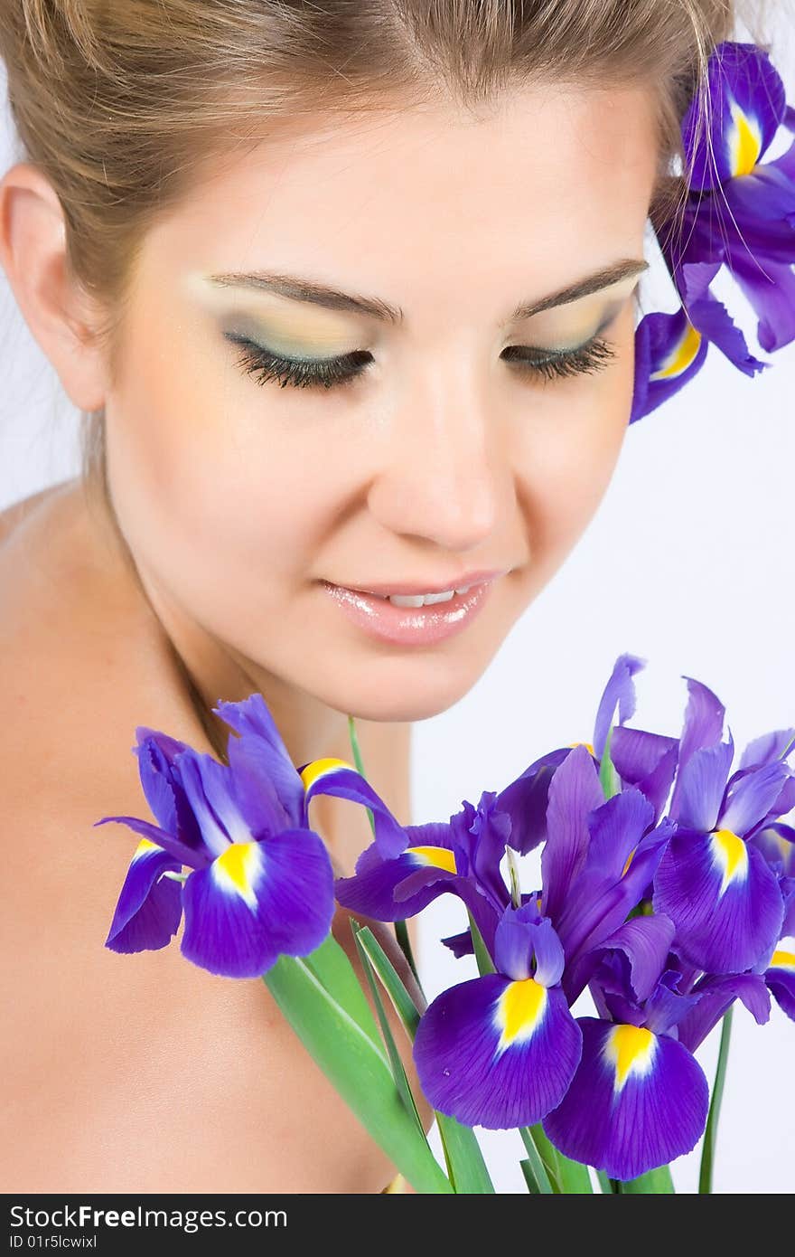 Blonde girl with gladiolus flower in hands isolated on white