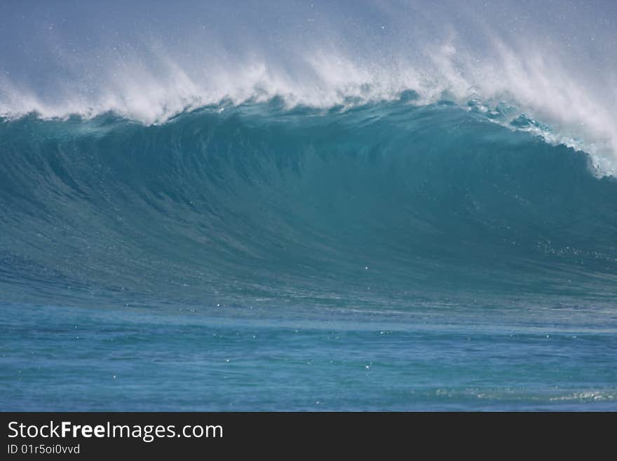 A perfect blue wave peeling. A perfect blue wave peeling