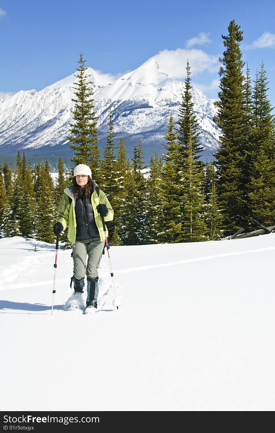 Woman snowshoeing in the Canadian rockies, british columbia