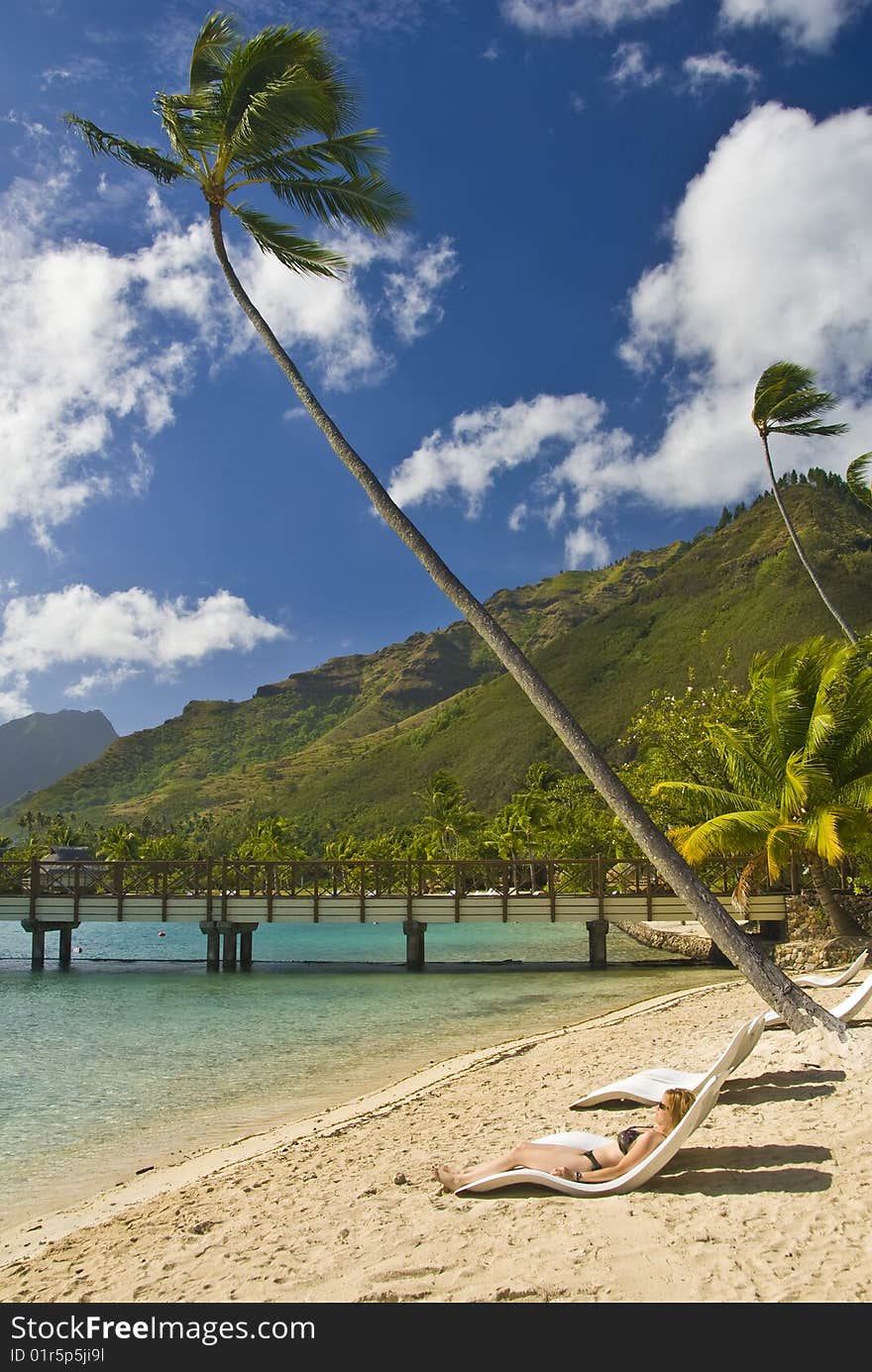 Girl laying on a beach in Moorea , Franch Polyensia