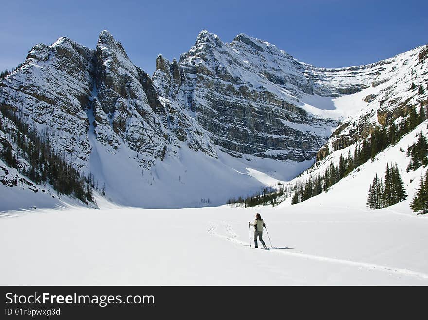 Woman snowshoeing in the Canadian rockies, near Lake Louise, Alberta