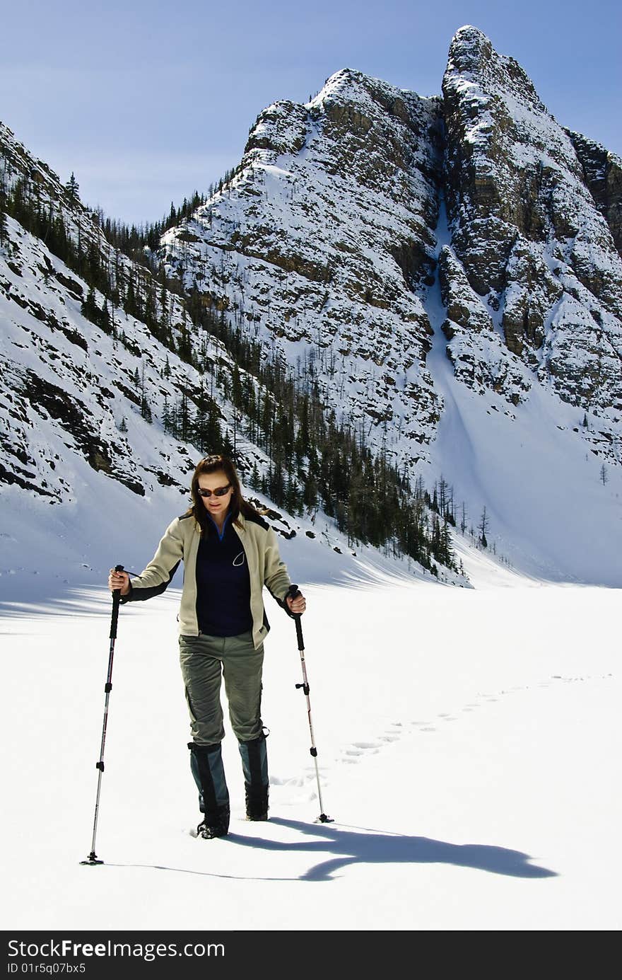 Woman snowshoeing in the Canadian rockies, near Lake Louise, Alberta