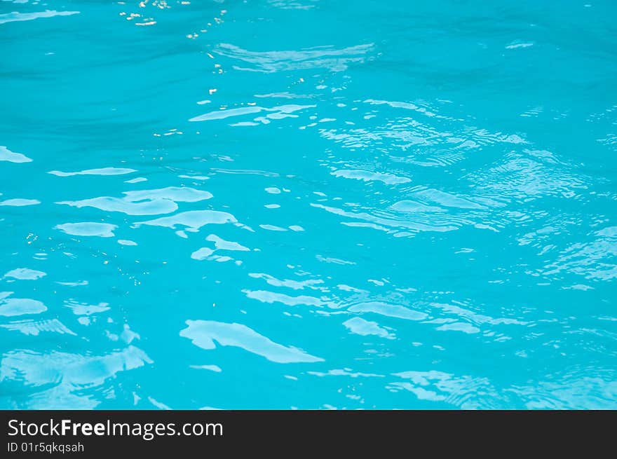 Light reflecting off of blue waves in a swimming pool. Light reflecting off of blue waves in a swimming pool.