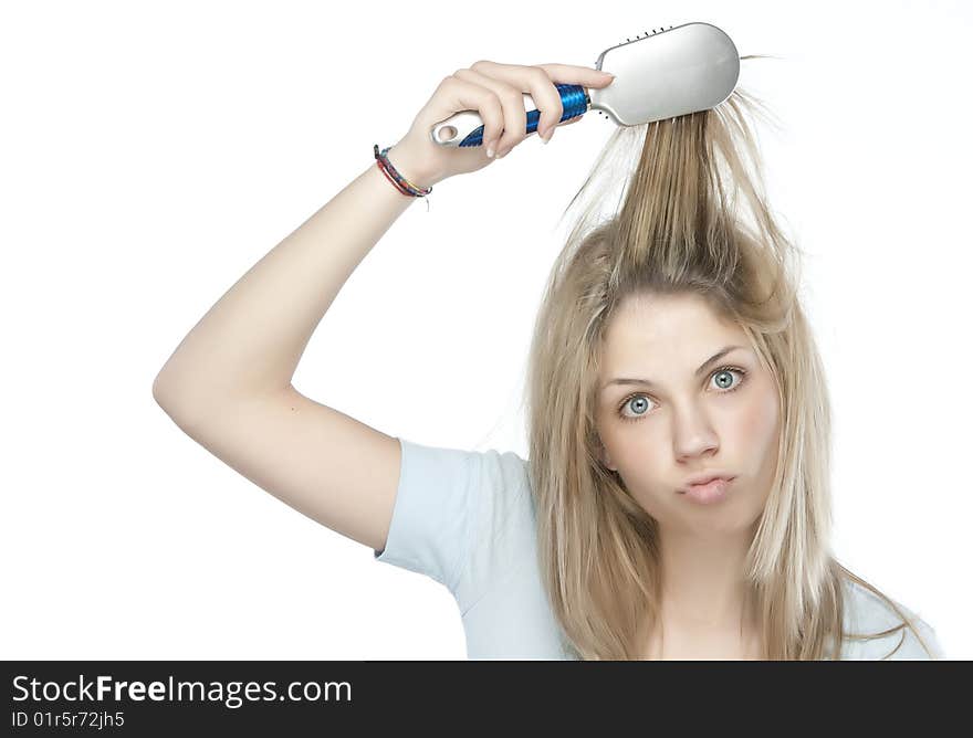 Beautiful young woman combing her hair