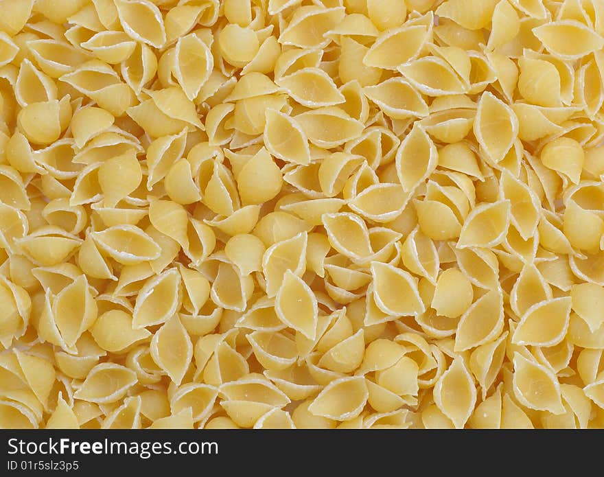 A lot of pasta small shell as back ground. A lot of pasta small shell as back ground