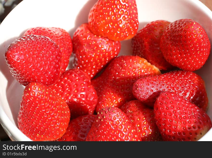 Several strawberries in white bowl, picked up, washed and ready to be eaten. Several strawberries in white bowl, picked up, washed and ready to be eaten