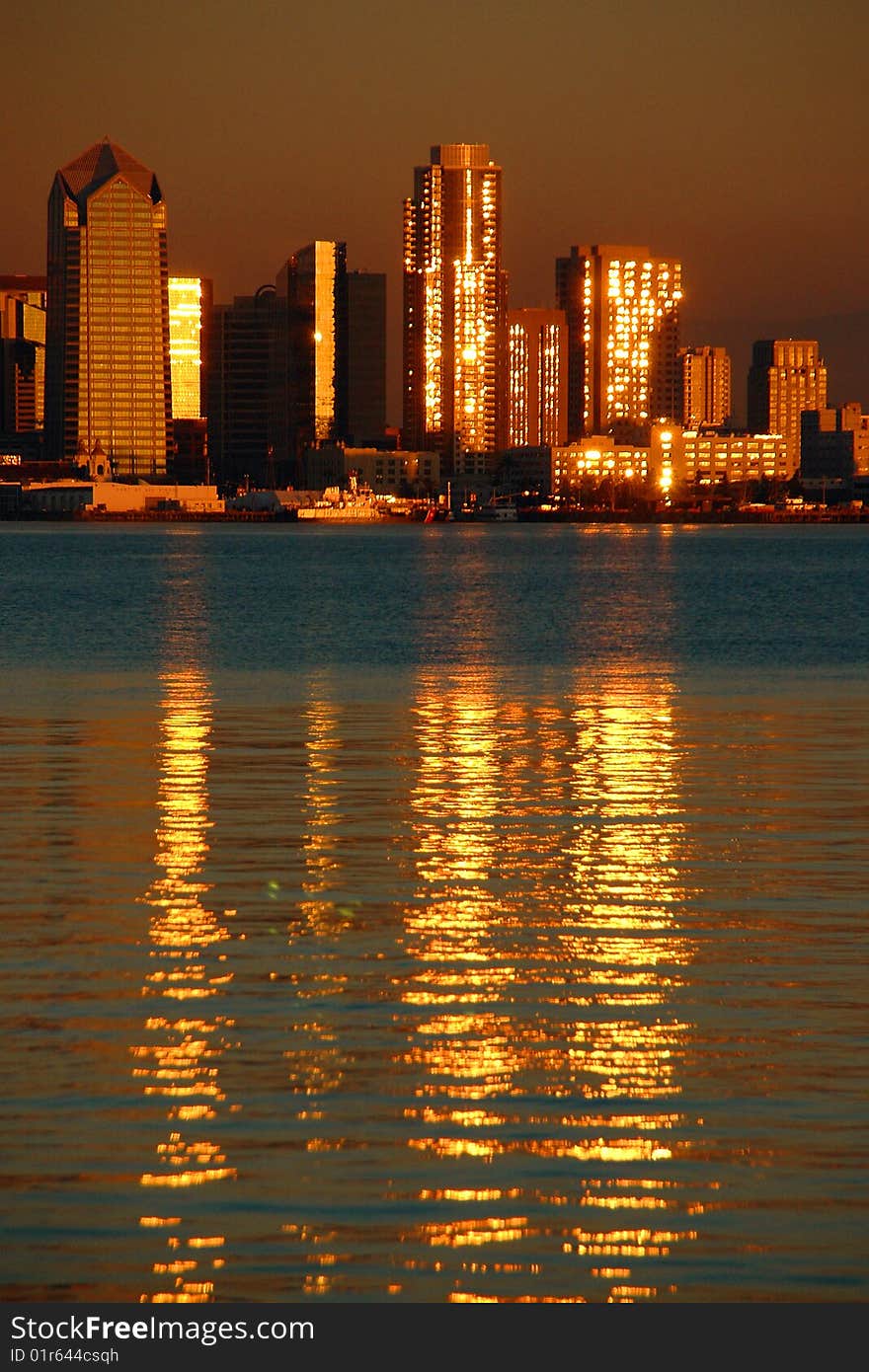 Setting sun casts a brilliant golden hue over the city on the bay. Setting sun casts a brilliant golden hue over the city on the bay.