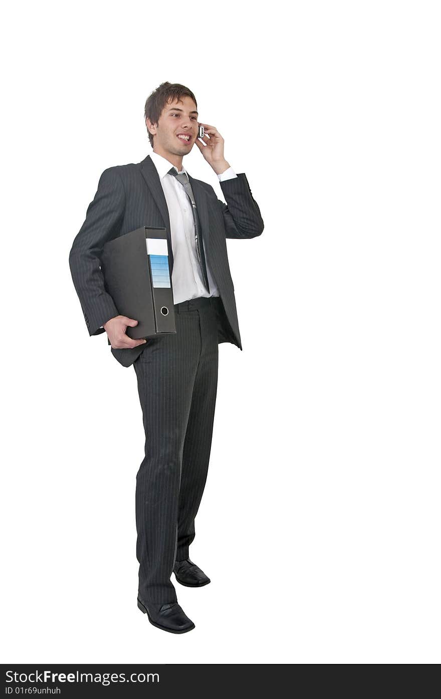 Young man in office talking on his cell