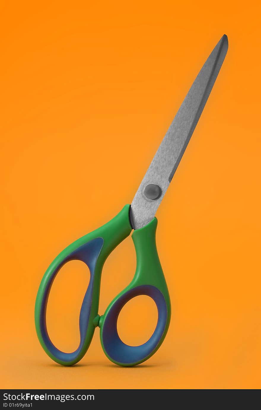 Scissors isolated on orange background. Scissors isolated on orange background