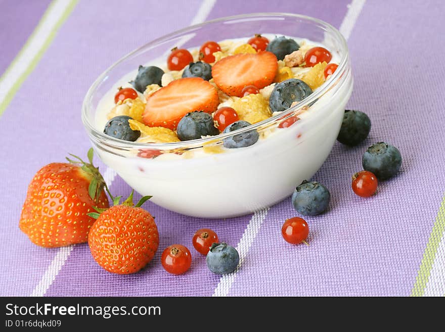 Bowl of corn flakes with fresh fruits and jogurt. Bowl of corn flakes with fresh fruits and jogurt