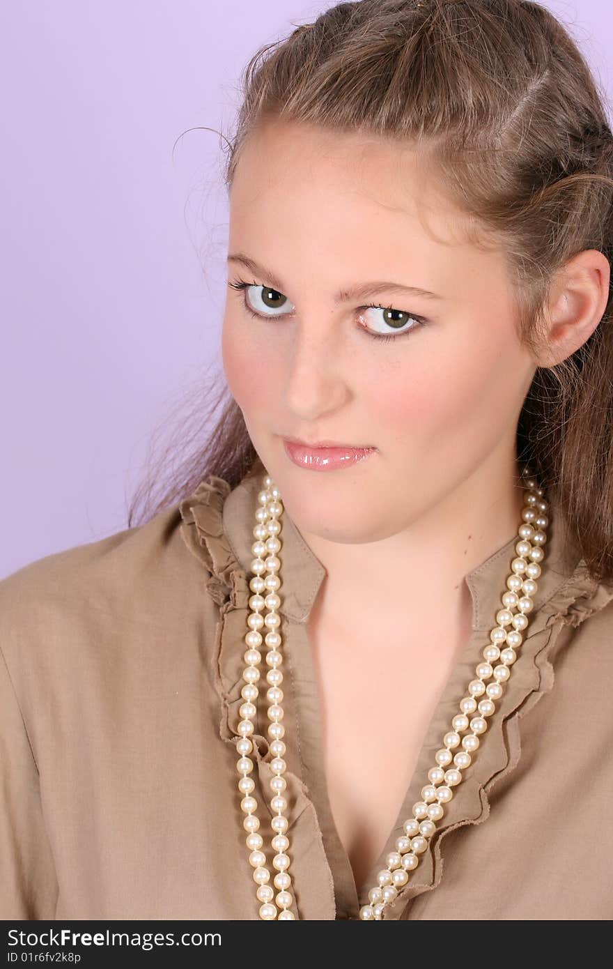 Beautiful teenage female against purple background, wearing pearls. Beautiful teenage female against purple background, wearing pearls