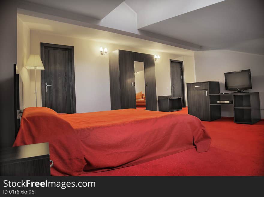 Hotel bedroom in colors red and grey empty