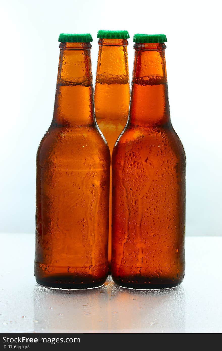 Three beer bottles abreast