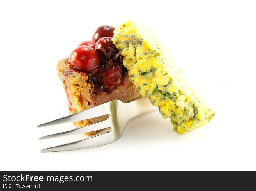 Slice of pork pie, blue cheese and a fork with clipping path on a white background. Slice of pork pie, blue cheese and a fork with clipping path on a white background