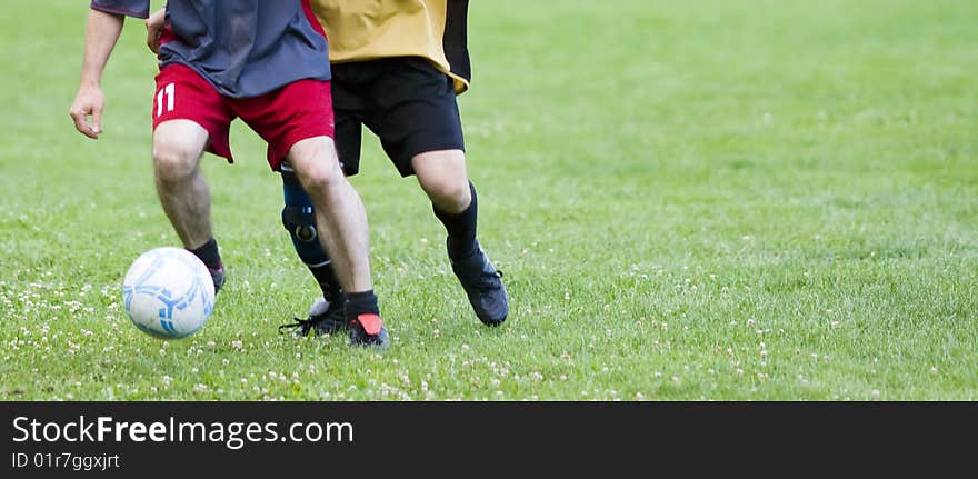 Soccer players fighting for the ball