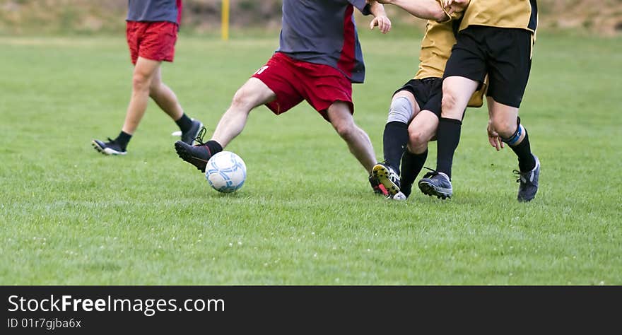 Soccer players fighting for the ball