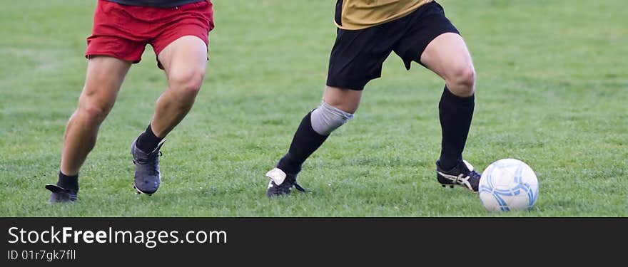 Soccer players fighting for the ball