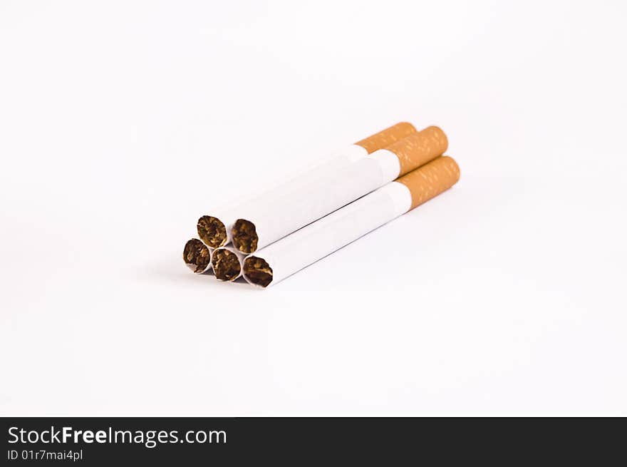Five cigarettes isolated on bright background