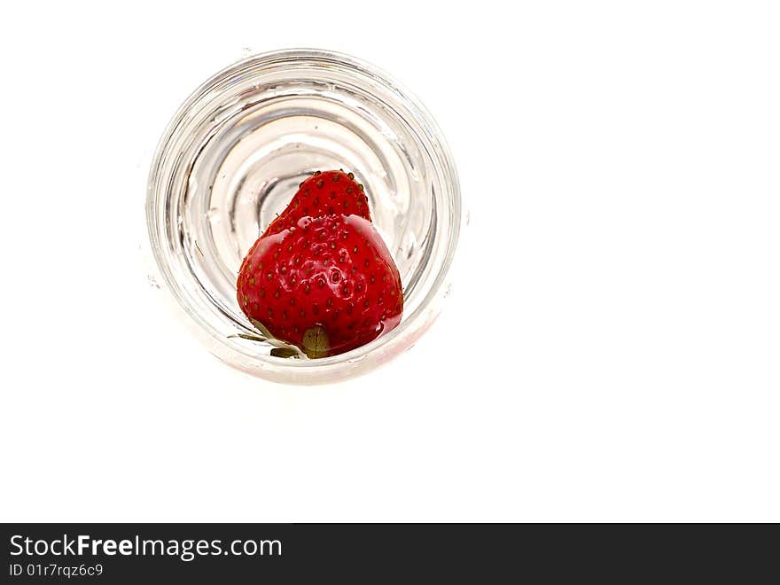 One strawberry on the glass isolated on white background