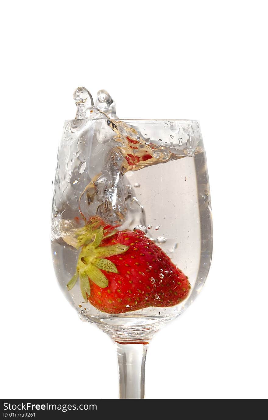 Strawberry in the clear water on white background in the glass. Strawberry in the clear water on white background in the glass