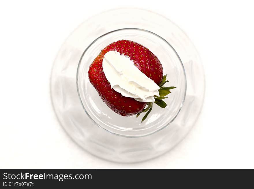 Red fresh strawberry on the whipped-cream in the glass on white. Red fresh strawberry on the whipped-cream in the glass on white