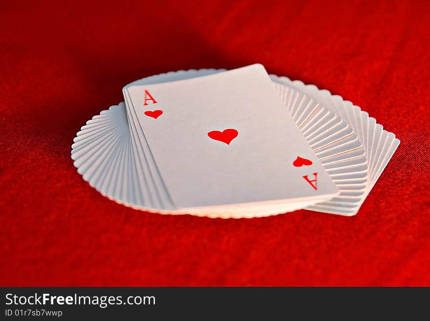 The pack of the playing cards which have been spread out by a fan. The pack of the playing cards which have been spread out by a fan