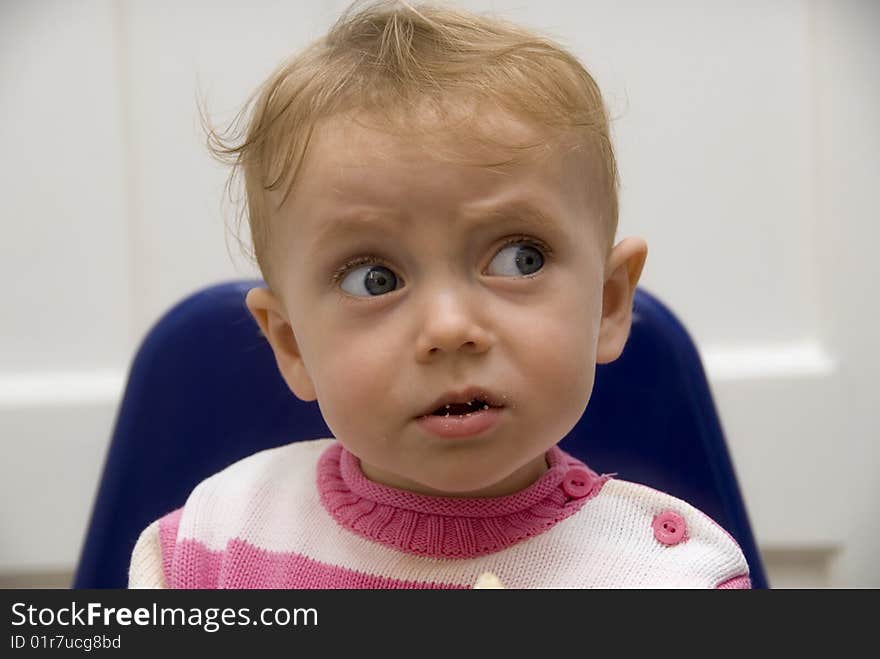 Portrait of baby looking to someone beside with big wondering eyes. Portrait of baby looking to someone beside with big wondering eyes