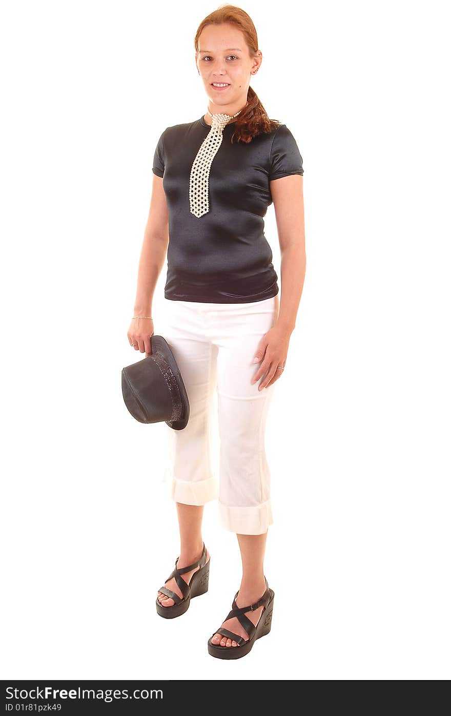 An all dressed up woman in black blouse and white trousers, with a hat in her hand and a necktie made from white pearls, for white background. An all dressed up woman in black blouse and white trousers, with a hat in her hand and a necktie made from white pearls, for white background.