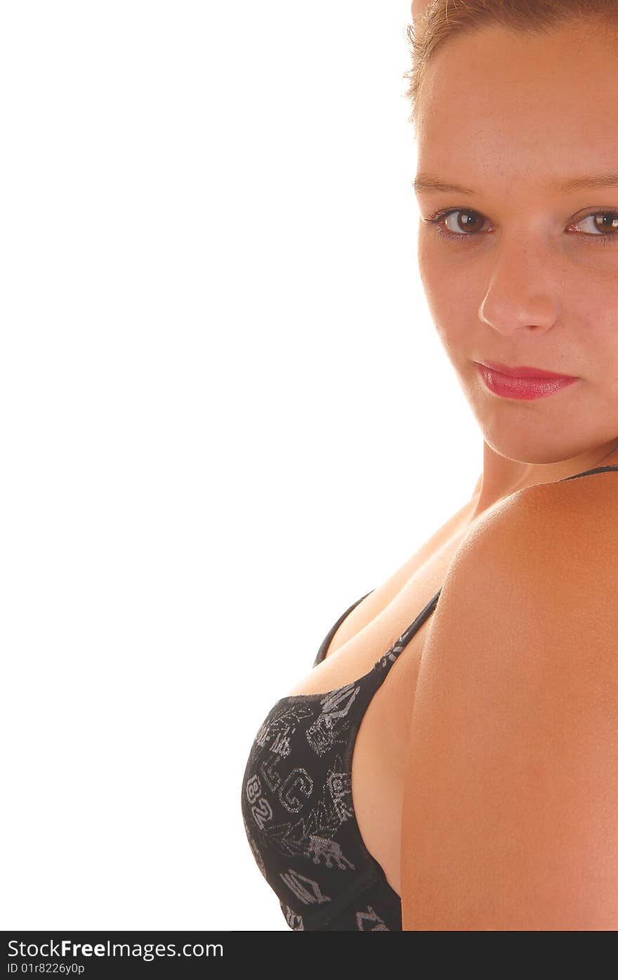 Young woman shooing her chest with an black bra with her small breasts in close up on white background. Young woman shooing her chest with an black bra with her small breasts in close up on white background.