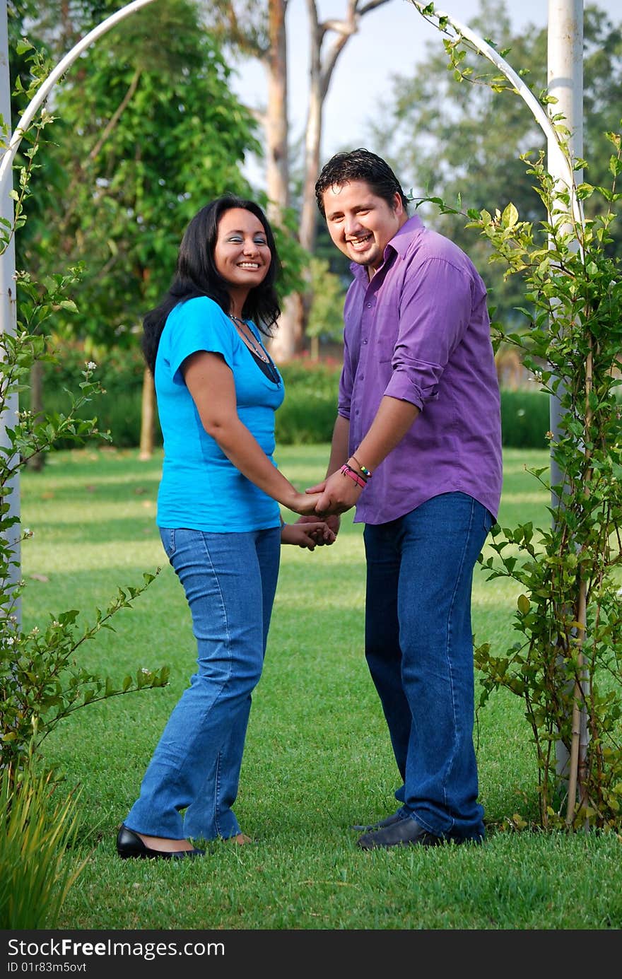 Beautiful Hispanic couple embracing in an outdoor setting. Beautiful Hispanic couple embracing in an outdoor setting