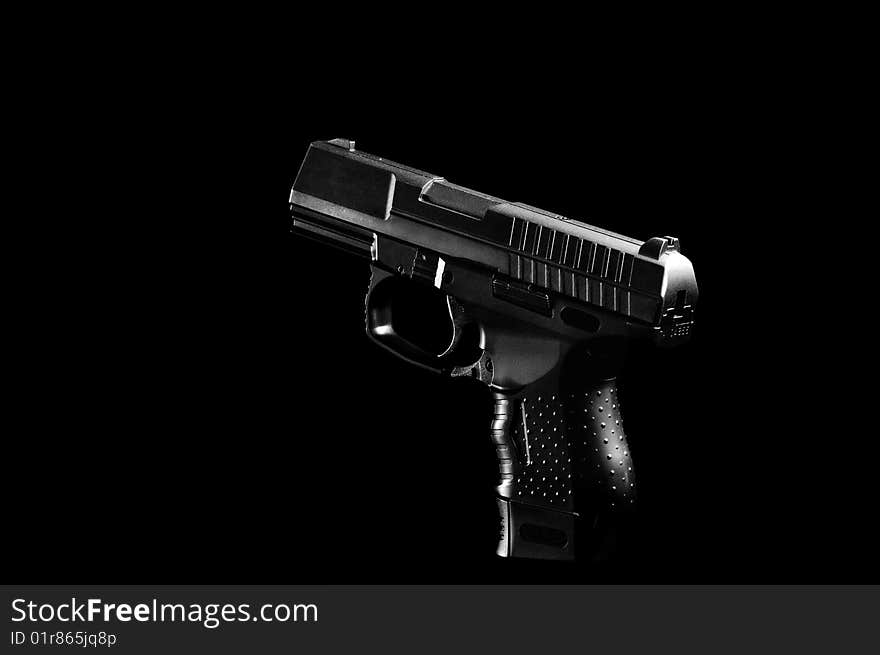 The black gun isolated on black background