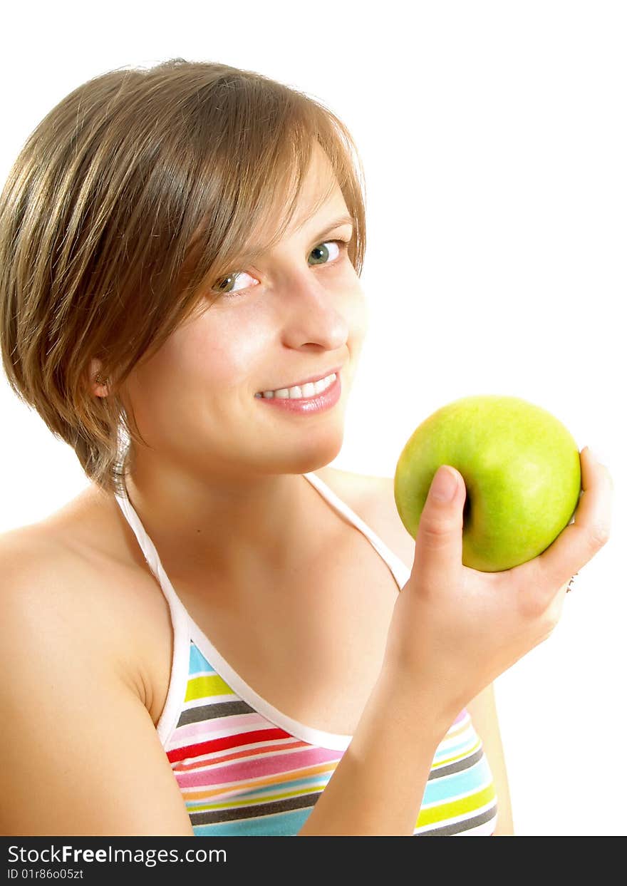 Portrait of a pretty Caucasian blond girl with a nice colorful striped dress who is smiling and she is holding a green apple in her hand. Isolated on white. Portrait of a pretty Caucasian blond girl with a nice colorful striped dress who is smiling and she is holding a green apple in her hand. Isolated on white.