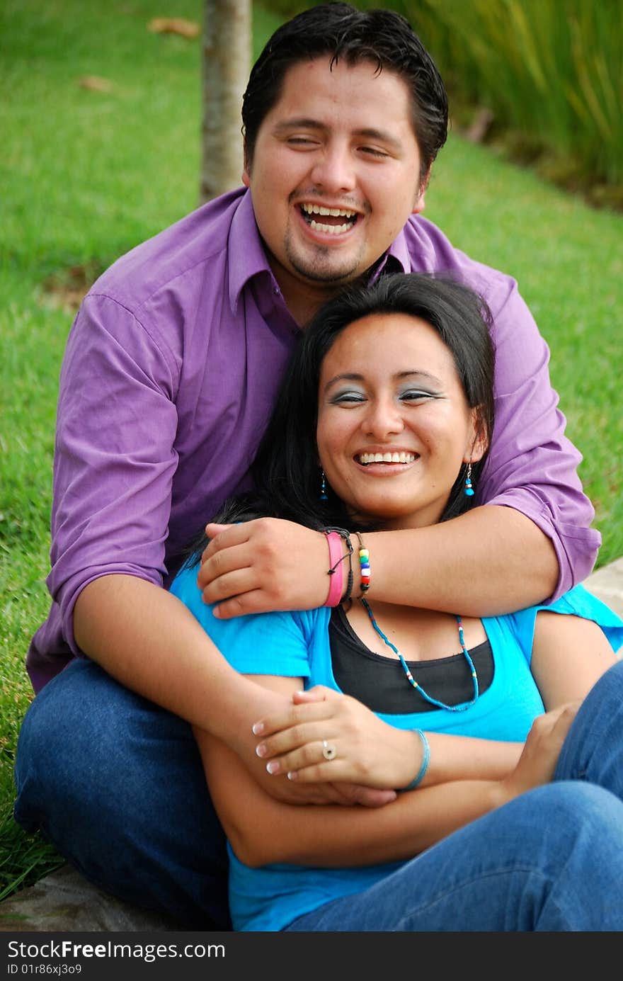 Beautiful Hispanic couple embracing in an outdoor setting. Beautiful Hispanic couple embracing in an outdoor setting