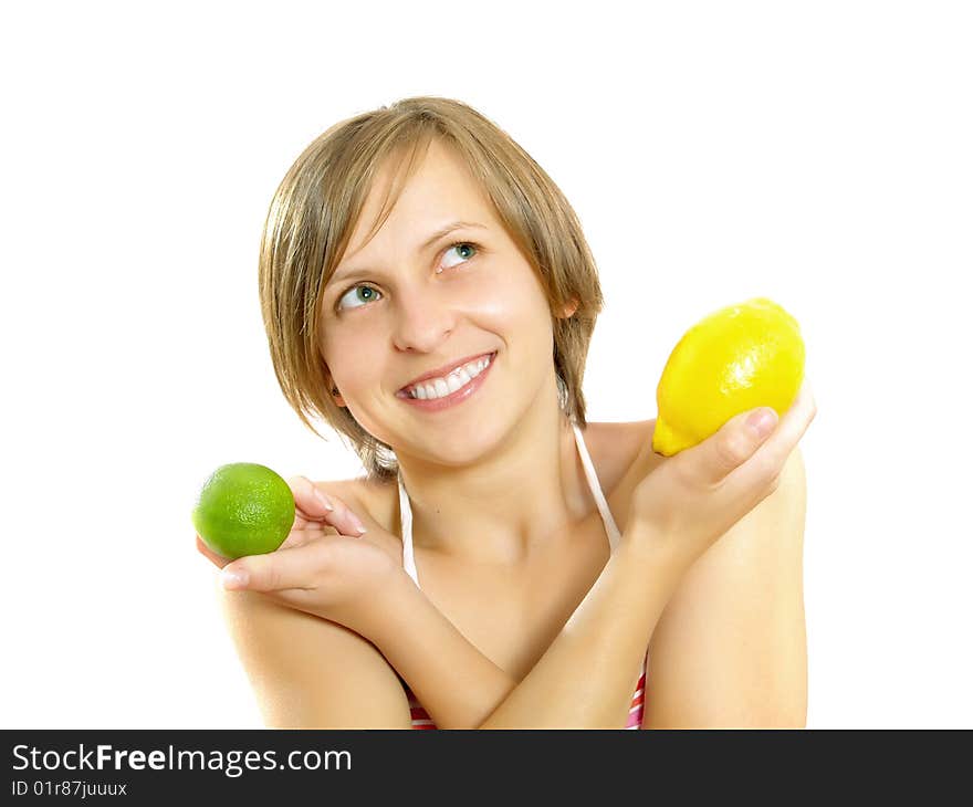 Portrait of a cute young Caucasian blond lady with a nice colorful striped summer dress who is smiling and she is holding a fresh lemon and a lime in her crossed hands. Isolated on white. Portrait of a cute young Caucasian blond lady with a nice colorful striped summer dress who is smiling and she is holding a fresh lemon and a lime in her crossed hands. Isolated on white.