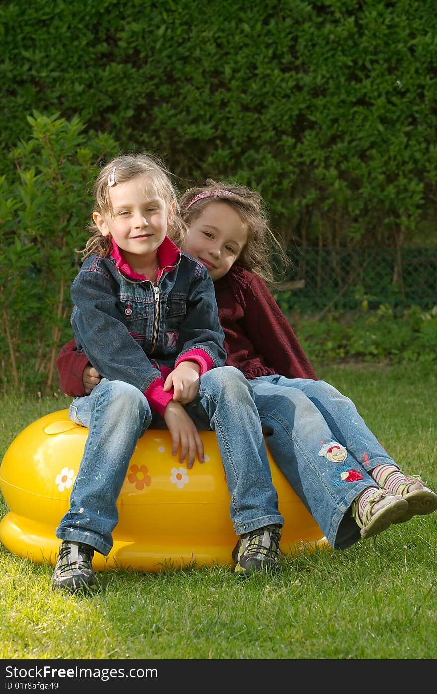 Two girls sitting in the garden. Two girls sitting in the garden