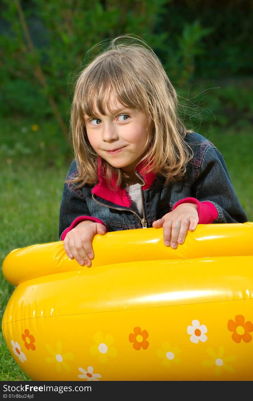 Young girl lies on the blown toy